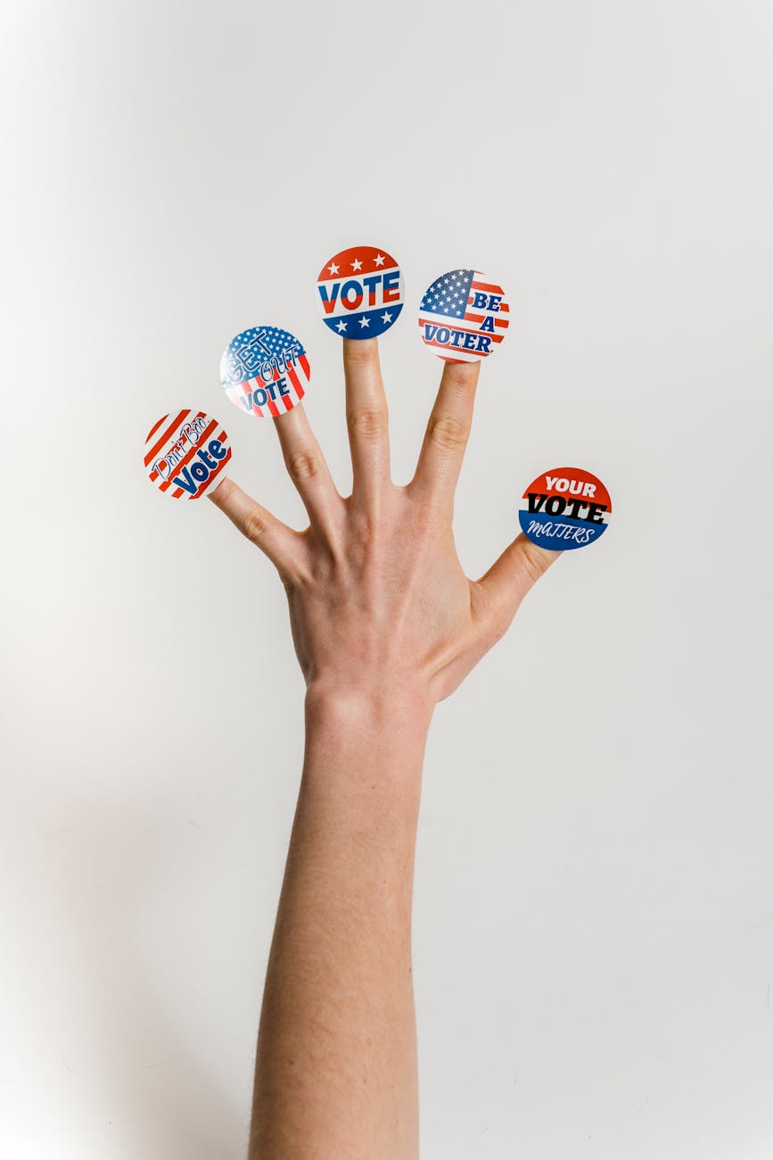 hand with vote stickers on fingers